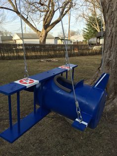 a blue swing that is attached to a tree