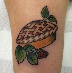 a tattoo with a pie and leaves on it