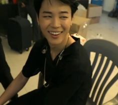 a person sitting on a chair smiling for the camera