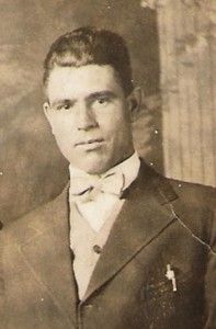 an old photo of a man wearing a suit and bow tie