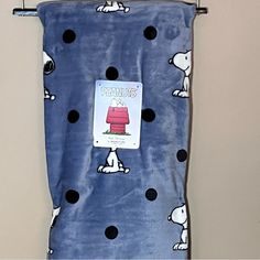 a towel hanging on the wall with a snoopy pattern and black polka dot dots