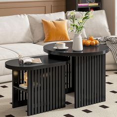 two black tables sitting on top of a white couch