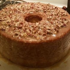 a cake sitting on top of a table covered in nuts