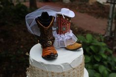 a wedding cake with cowboy boots on top