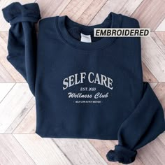 This self care sweatshirt is designed for all women. Let it remind you that self love is the greatest present you can give yourself. SIZING: * Sizing is unisex * Runs true to size * For an oversized look we suggest to size up 1 to 2 sizes PRODUCT DETAILS: * 100% cotton face * 65% cotton, 35% polyester * Self-fabric patch on the back * Designed and printed in the USA Please note that the embroidery comes with a backing that acts as a stabilizer to support the fabric and stitches. CARE INSTRUCTION Company Sweatshirt Ideas, Vintage Sweatshirt Design, Embroidered Relaxed Fit Crew Sweatshirt, Everyday Relaxed Fit Sweatshirt With Embroidered Text, Crewneck Design Ideas, Black Embroidered Text Sweatshirt Crew Neck, Cotton Hoodie With Embroidered Text, Crew Neck, Self Care Sweatshirt, Cotton Sweatshirt With Embroidered Text, Relaxed Fit