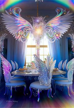 an artisticly decorated dining room table and chairs with angel wings on the chandelier