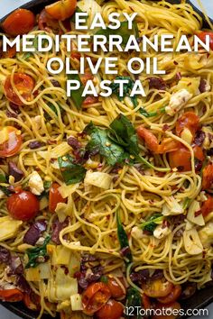 a skillet filled with pasta, tomatoes and other ingredients to make an easy mediterranean olive oil pasta