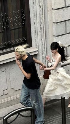 a man and woman walking down the street