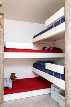 there are bunk beds in this room with red carpet on the floor and white walls