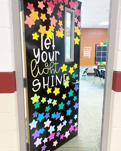 a door decorated with colorful stars and the words let your light shine on it's side