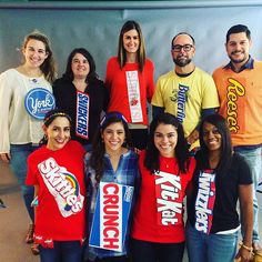 a group of people standing next to each other in front of a wall with signs on it