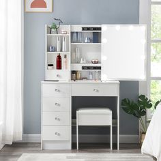 a white desk with a mirror and stool