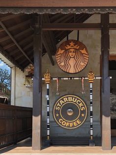 the starbucks coffee sign is on display in front of the entrance to the building that houses it