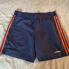 Adidas Athletic Shorts | Climalite Color: Blue W/Orange Stripes Elastic Waistline Size: M Usa/Uk These Shorts Are Super Lightweight. Comfortable To Wear 100% Polyester Adidas Casual Athletic Shorts With Go-dry Technology, Adidas Casual Athletic Shorts With Go-dry, Blue Adidas Athletic Shorts For Training, Adidas Blue Athletic Shorts For Training, Sporty Orange Training Bottoms, Sporty Orange Bottoms For Training, Adidas Blue Shorts For Gym, Adidas Blue Gym Shorts, Adidas Blue Shorts For The Gym