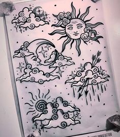 the sun and clouds are drawn in black ink on white paper with some other things