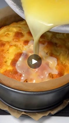 someone is pouring cheese on top of a casserole