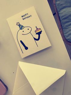 a birthday card sitting on top of an envelope next to a piece of paper that says happy birthday