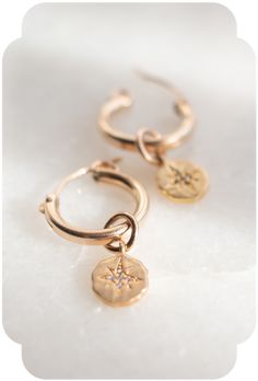 Make a statement daily with the timeless appeal of gold hoop earrings! Style these earrings with a white tee and black leather jacket, a patio dress on a warm summer evening, or with that power suit at the office. Ready to elevate your everyday chic? #goodwknd #goodweekend #jewelryaesthetic #goldhoopearrings #goodearrings Dainty Rose Gold Tarnish-resistant Huggie Earrings, Celestial Style Huggie Earrings With Star Charm, Rose Gold 14k Gold Filled Huggie Earrings, Dainty 14k Gold Filled Huggie Cartilage Earrings, Celestial Hoop Jewelry With Star Charm, 14k Gold Filled Earrings With Star Charm As Gift, Celestial Hoop Earrings With Star Charm For Everyday, Celestial Gold Plated Tarnish Resistant Hoop Earrings, Dainty Gold Plated Tarnish Resistant Huggie Earrings