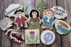 some cookies with different designs on them sitting on a wooden table next to each other