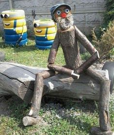 a wooden statue sitting on top of a log in front of some fake minion's