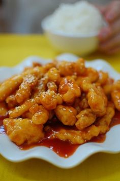 a white plate topped with fried food on top of a yellow table