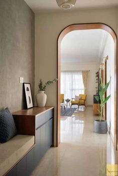 an archway leads to the living room and dining area in this modern home with beige walls