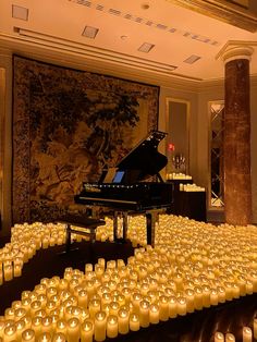 a room filled with candles and a grand piano