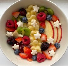 a white bowl filled with fruit and cereal