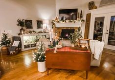 a living room filled with furniture and christmas decorations