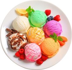 a white plate topped with lots of different flavored ice creams next to fruit