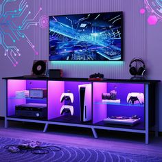 an entertainment center with purple lighting and electronic equipment in front of a large television screen