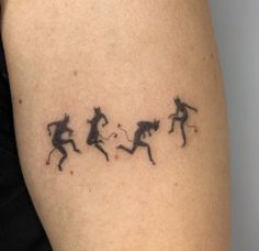 the tattoo on the arm shows three silhouettes of men and women running in opposite directions