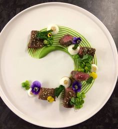 a white plate topped with food on top of a table