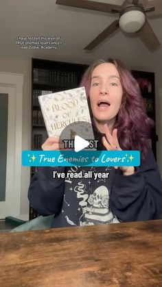 a woman with purple hair holding up a book in front of her face and the caption reads true experiences to lover? i've read all year