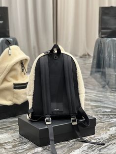 Description   S.L Fleece Backpack Beige For Women, Women’s Bags 16.1in/41cm YSL  Rep 1:1  Size:  31 x 41 x 22 cm / 12.2 x 16.1 x 8.6 inches (Length x height x width)  Shearling backpack in beige. Buffed and canvas trim in black throughout. Grosgrain carry handle in black at top. Logo plaque on detachable lanyard at handle base. Twin adjustable padded shoulder straps. Zippered compartment and logo stamp in silver-tone at face. Earphone opening and card slot featuring logo stamp in silver-tone at back face.  Two-way zip closure at main compartment.  Zippered pocket patch pocket laptop compartment and logo patch at interior.  Textile lining in black.  Silver-tone hardware.  Tonal stitching.  Includes dust bag.  This product is of the best quality. Yves Saint Laurent Bags, Saint Laurent Bag, Branded Handbags, Logo Stamp, Luxury Accessories, Christmas Sale, Grade 1, Exclusive Collection, Travel Luggage