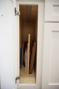 an open cabinet with several pieces of luggage in it