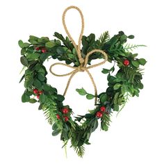 a heart shaped wreath with green leaves and red berries