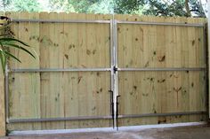 a large wooden fence with two doors on each side