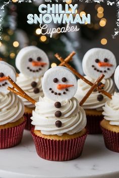 cupcakes decorated with frosting and snowmen on top