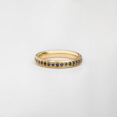 "A Beautiful full eternity ring with an oval profile made in 18k gold. Wear it as a stacking ring / engagement band, or next to a matching wedding ring. Set with 0.55 Ct Blue Sapphires to create a piece of jewelry that is comfortable and classy. Our eternity rings are characterized by a bold setting, creating a Gobelin-like ornament. Stacked together in multi layers they create a wonderful, colorful texture. You're free to choose the colors and the combinations. Stones: Natural (Untreated) Blue Matching Wedding Ring, Stacked Engagement Ring, Colorful Texture, Eternity Rings, Full Eternity Ring, Gold Anniversary, Engagement Band, Sapphire Wedding, Ring Blue