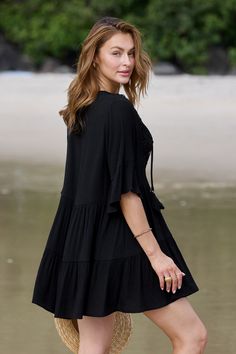 Turn heads at the beach with our Black Half Sleeve Tassel Tie Mini Cover-Up Dress! Featuring playful tassel ties and flattering half sleeves, this versatile piece effortlessly transitions from beachside chic to poolside glamour. Product code: DAA07B4B017AA Features:  Woven Plunging neckline Tassel tie Lace detail Mini Wash Method: Regular Wash Material: 60%RAYON,40%POLYESTER. Black Beach Dress With 3/4 Sleeve, Black 3/4 Sleeve Beach Dress, Summer Beach Dress With Back Tassel Tie-up For Vacation, Beach Dresses With 3/4 Sleeves For Summer, Summer V-neck Cover-up With Drawstring, Flowy Short Sleeve Beach Dress For Summer, Beach Season Dresses With Back Tassel Tie-up, Bohemian Half Sleeve Dresses For Vacation, Chic Mini Dress With Drawstring For Vacation