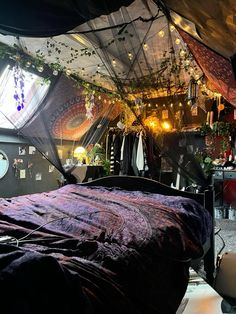 a bed sitting under a canopy in a bedroom