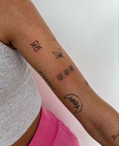 a woman's arm with tattoos on it, and an arrow in the middle