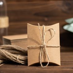 a brown paper wrapped in twine on top of a wooden table