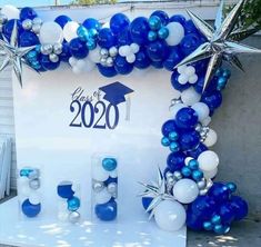 blue and white graduation decorations on display in front of a sign that says class of 2020