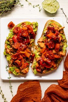 two open faced sandwiches on a white plate