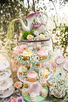 a table topped with lots of cupcakes and cakes