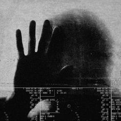 the silhouette of a person's hand in front of a computer screen with numbers on it