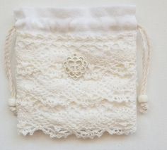 a white lace pouch with a heart on it