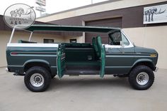 a green truck parked in front of a building